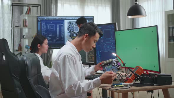 Asian Team Of Multi Engineers, Scientists Work On Green Chroma Key Screen Computer, Talk