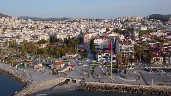 Waving Flag With Ataturk Peace Monument On The Seafront Promenade Of Kusadasi, Turkey. Aerial Shot