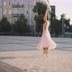 Graceful Woman Spins on Pointe Shoes Raising Hands on Square - VideoHive Item for Sale