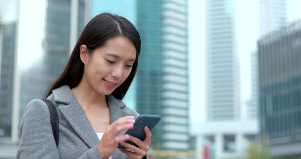 Businesswoman use of smart phone in Hong Kong