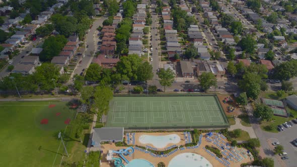 Flying Over a Pool Complex and Towards a Suburban Neighborhood in Long Island