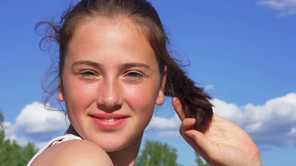 Portrait of a Happy Teenage Girl Outside on a Sunny Summer Day