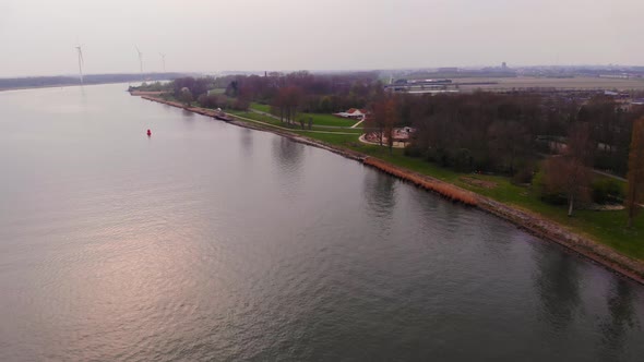 Aerial Towards Oude Maas Riverbank. Pedestal Down Dolly Forward