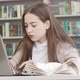 Teenage Girl Using Computer at the Library - VideoHive Item for Sale