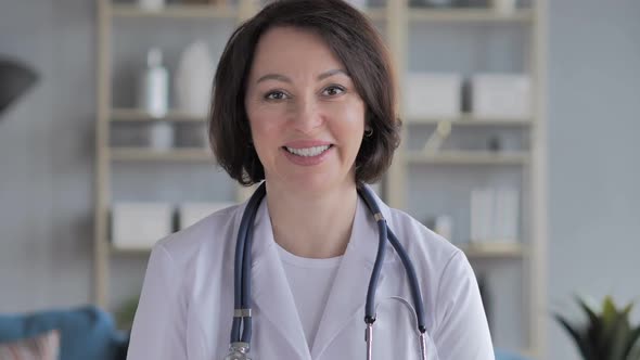 Portrait of Smiling Old Lady Doctor Looking at Camera