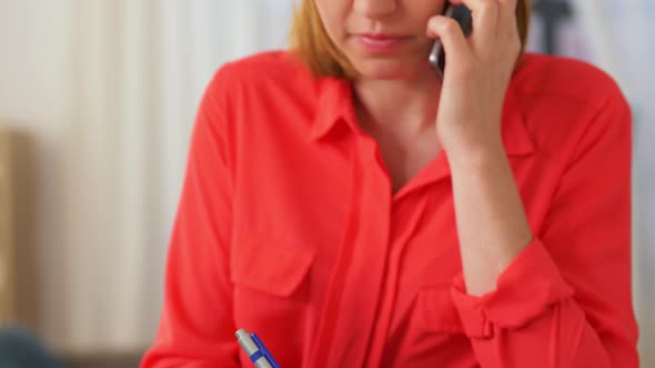 Woman Calling on Smartphone at Home Office