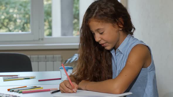 Adorable Long Haired Girl Enjoying Drawing at School, Smiling To the Camera 1080p