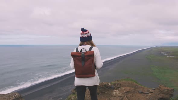 Back View of Young Attractive Girl Enjoing View of Mountain Landscape and Ocean Slow Motion