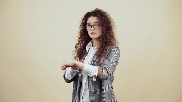 The Smoky Teacher Shows the Gesture That you are Late While Looking Seriously in the Room