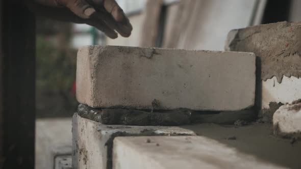 Construction Worker or Mason Laying Bricks and Creating Walls. Bricklayer Laying Bricks To Make a