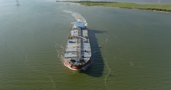 Aerial establishing shot of large tanker boat in water