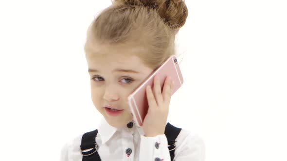 Girl Child Communicates By Mobile Phone on White Background