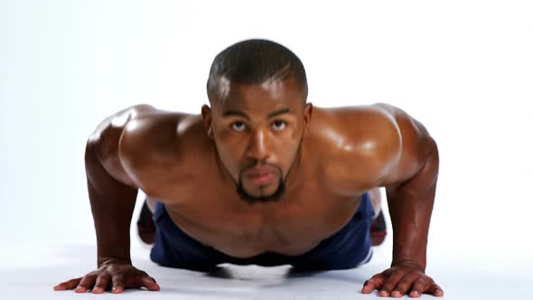 Fit man exercising on white background 4k