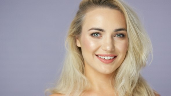 Joyful Young Blonde Woman in Studio