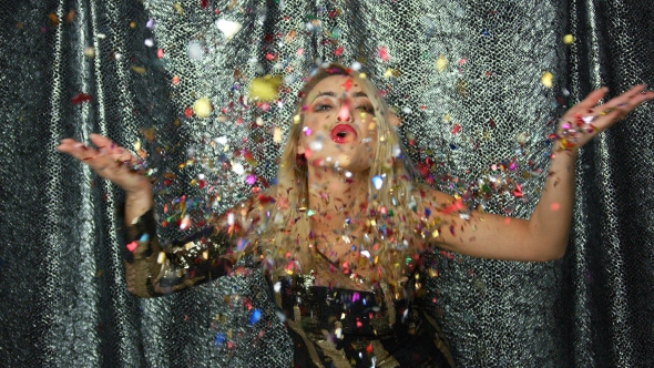 Woman Throwing Up and Blowing at Confetti