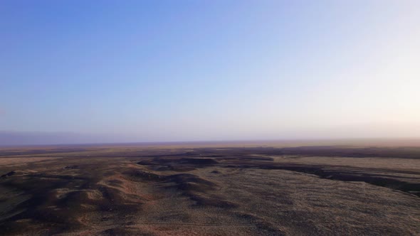 Beautiful Aerial Shot of an Endless Lush Field and the Horizon of Majestic Sky