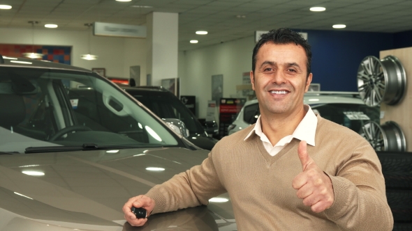 A Good Man Examines the Car Salon and Shows a Thumbs Up