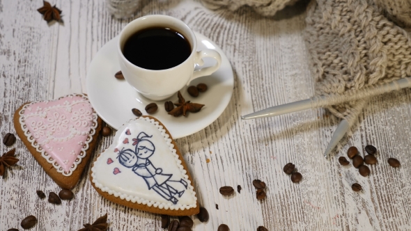 Couple Relations St Valentine`s Day Concept A Cup of Coffee and Ginger Biscuit with Knitting