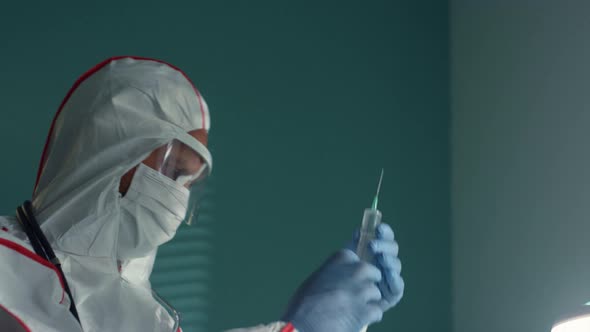 Doctor Prepare Syringe Vaccine in Protective Suit