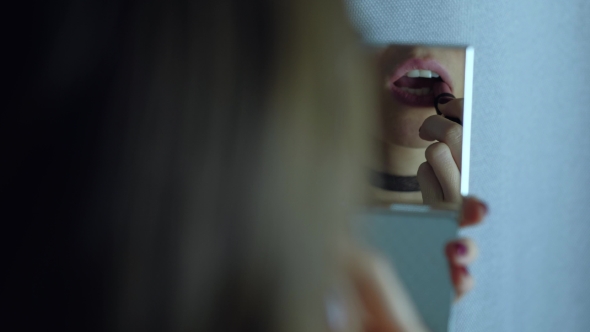 Female Lips Reflected in the Mirror.