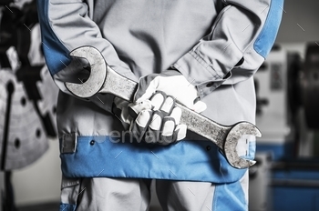Metal Wrench in Hands.