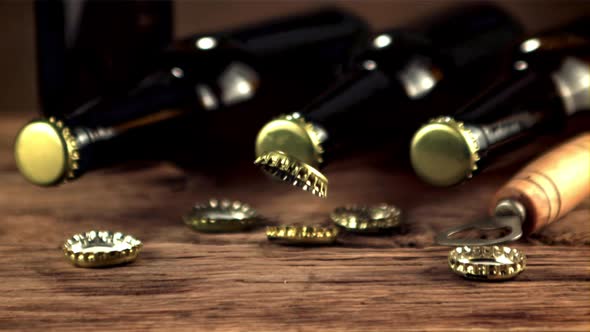 Super Slow Motion Lids From Beer Bottles Fall on the Table