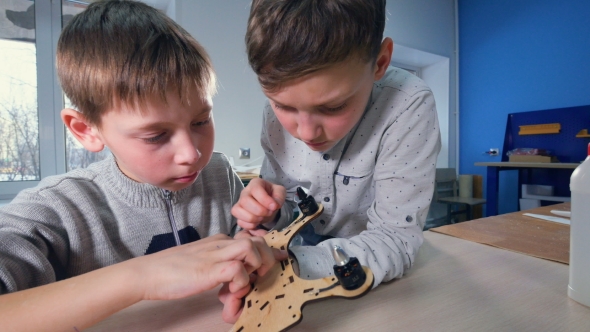 Two Boys Are Finishing Their Wooden Drone Model