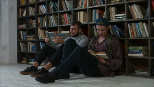 Students Sitting in Front of a Bookshelf Talking