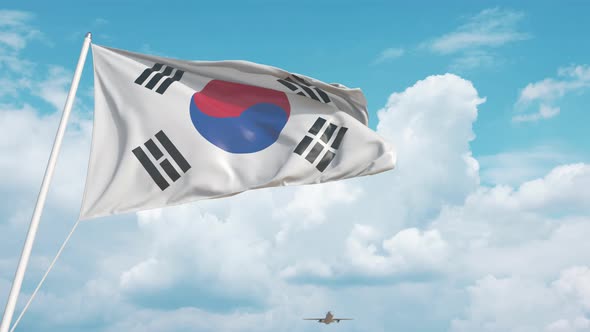 Commercial Airplane Landing Behind the Korean Flag