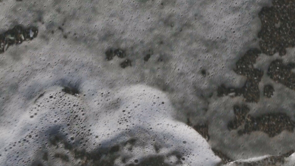 Man Walking Bare Foot on Sandy Beach Into Sea Wave