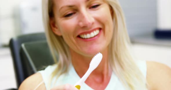 Woman holding tooth brush