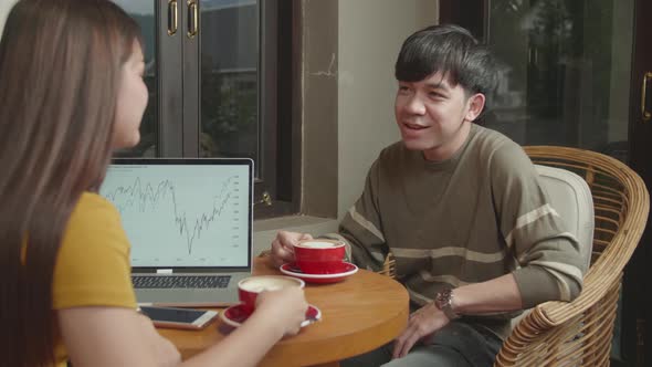 Two Young Asian Woman And Man Talking At Coffee Shop