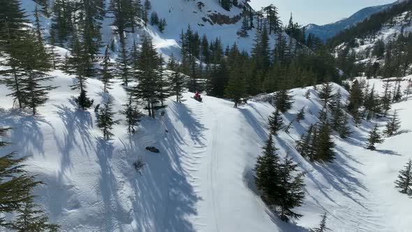 Snowmobile high in the mountains aerial view 4 K