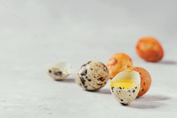 ail eggs with yolk and shell over white texture background. Close up, copy space. Toned image