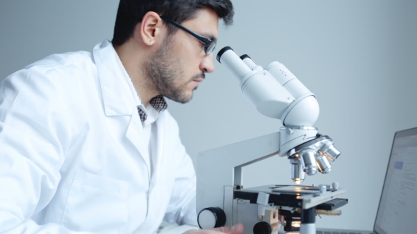 Young Scientist Looking Through Microscope alt