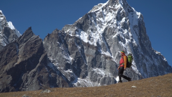 A Man with a Backpack in the Himalayas