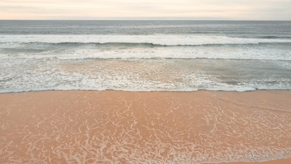 Sea Waves Over Sand Beach Background