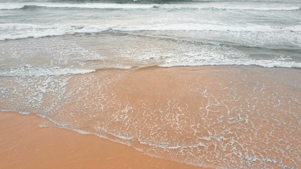 Sea Waves Over Sand Beach Background