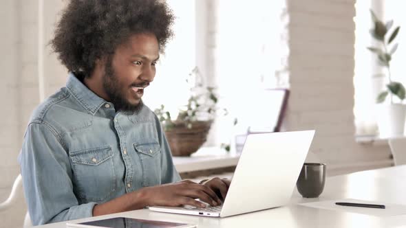 Creative African Man Celebrating Success at Work