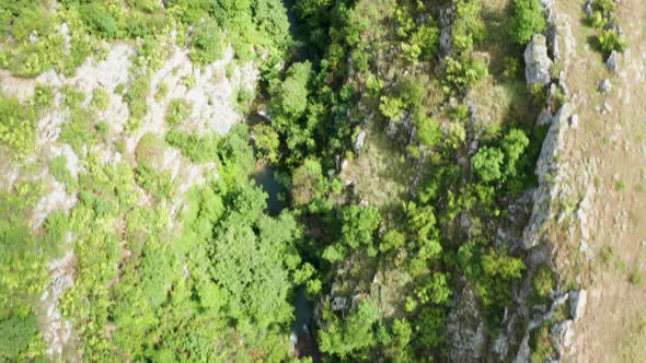 Aerial Drone Top Down Footage of Canyon with a River and Waterfalls