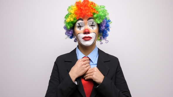 Conceptual Footage of Clown in Business Suit Arranging Her Tie