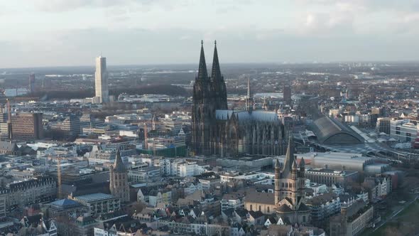 AERIAL: Wide Shot of Cologne Germany From the Air with Majestic Cathedral on Sunny Day 