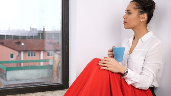 Woman Next to a Big Window