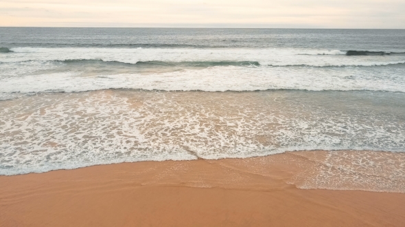 Sea Waves Over Sand Beach Background
