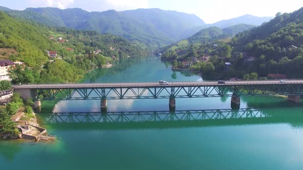 Side view of cars driving on bridge over water