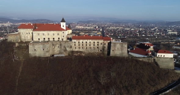 Beautiful Panoramic Aerial View To Palanok Castle at Sunset and the City of Mukachevo