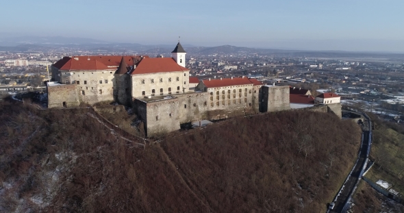 Beautiful Panoramic Aerial View To Palanok Castle at Sunset and the City of Mukachevo