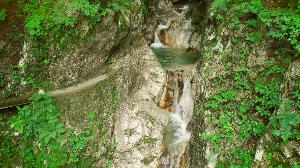 Aerial view of small waterfalls surrounded by big rocks at Soca river, Slovenia.