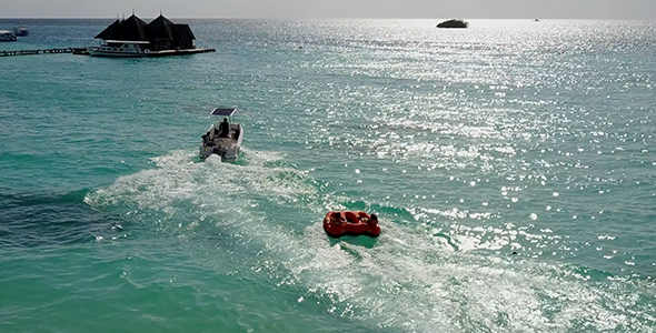 Aerial Boat Tube (donut) Being Pulled behind Boat