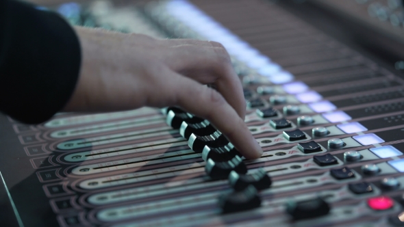 Man Working at an Event Audio Mixer Knobs Being Pulled Hand Presses the Keys